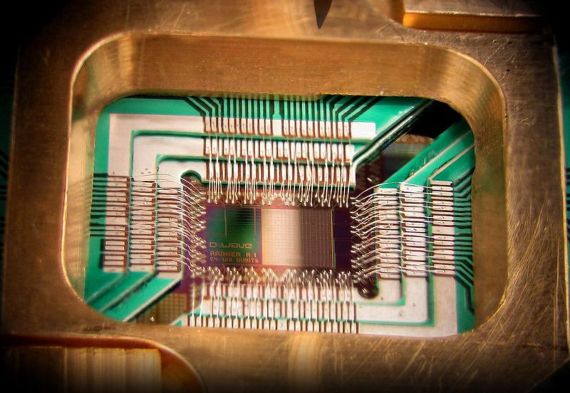 Photograph of a chip constructed by D-Wave Systems Inc. designed to operate as a 128-qubit superconducting adiabatic quantum optimization processor, mounted in a sample holder.